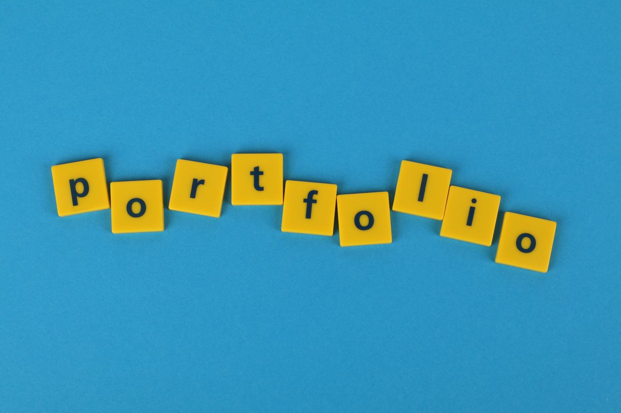 services-04 Yellow Scrabble tiles on a blue background spelling 'portfolio'. Perfect for business themes.